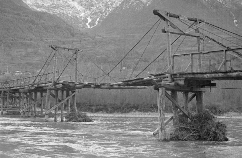 Il ponte sulla Dora – dall’aspetto a dir poco precario – che collegava Quart e Brissogne prima che venisse costruito quello successivo che fu inaugurato nel 1952 (Foto Octave Bérard, Regione autonoma Valle d'Aosta – Archivio Brel – Fondo Bérard)